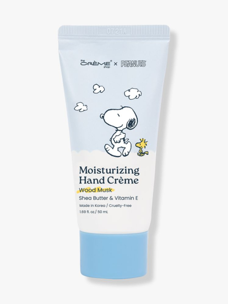 The Crème Shop x Peanuts Moisturizing Hand Crème in Citrus Woods light blue tube with Snoopy on light gray background